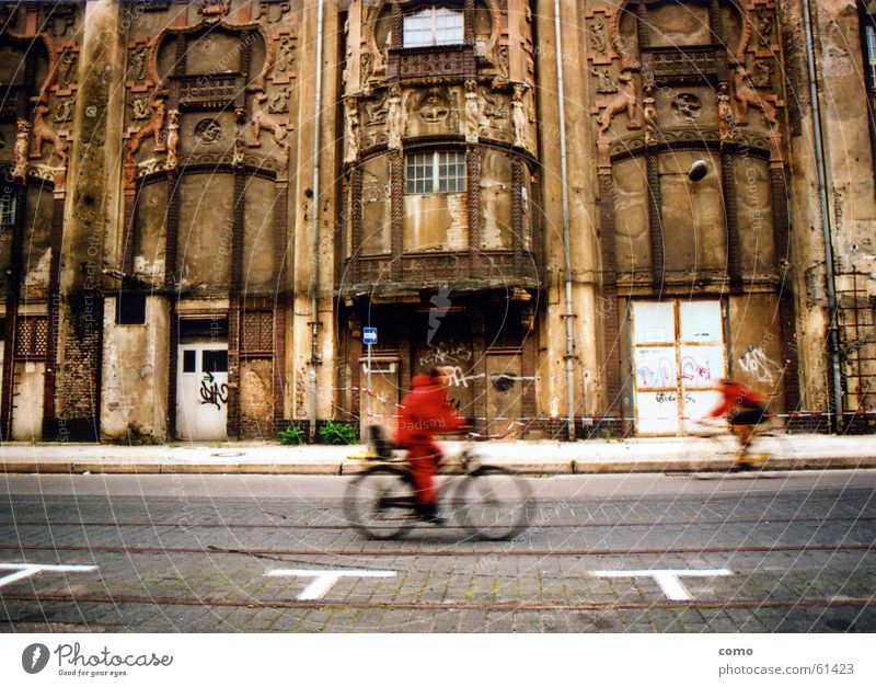 Volatile Red Bicycle Downtown Berlin Monument Dismantling Fleeting Speed Traffic infrastructure Transience Derelict Street pass old house chipped bricks
