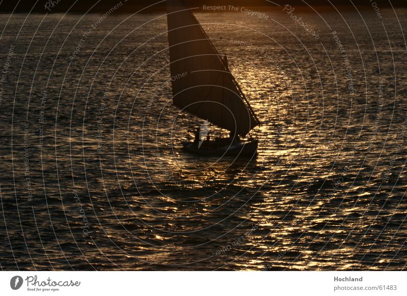Evening at the Nile Egypt Dusk Sunset Waves Reflection Watercraft Dream Transcendence Ferryman River Sail sails in the light felluke rich in dead