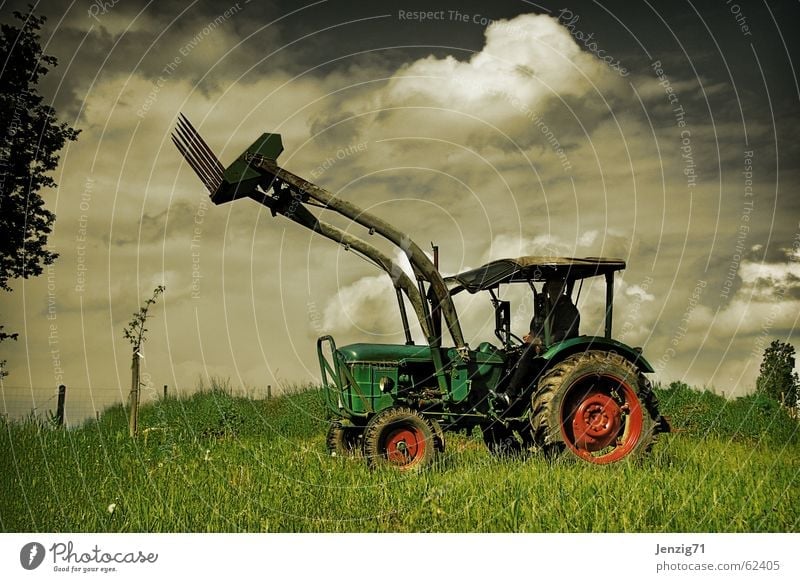 Country star. Tractor Agricultural machine Field Driving Machinery Meadow Clouds Work and employment Toys Farmer Pasture Sky