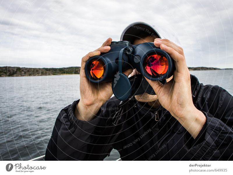 Young man looking with binoculars on the Baltic Sea in Sweden Lifestyle Leisure and hobbies Sports Sailing Human being Masculine Youth (Young adults) Head 1