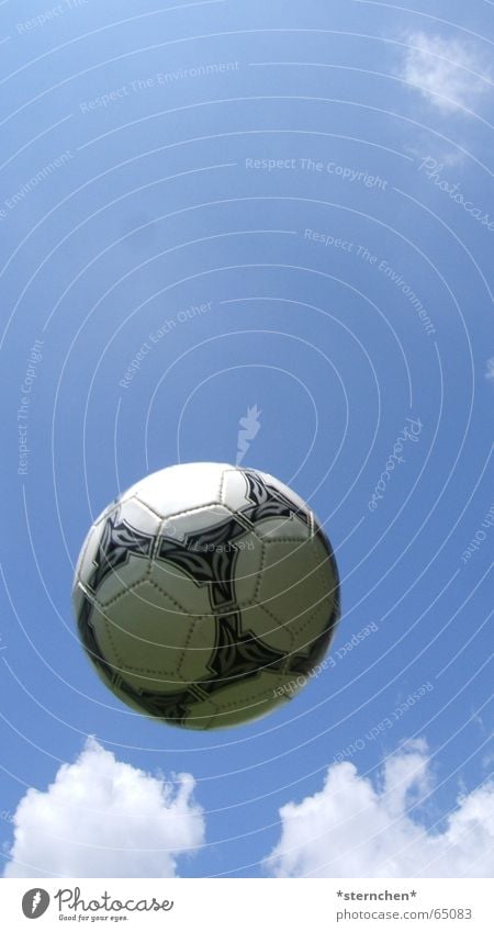 High in the air Soccer Ball Sky Clouds Flying Throw Bright Round Blue Black White Exterior shot