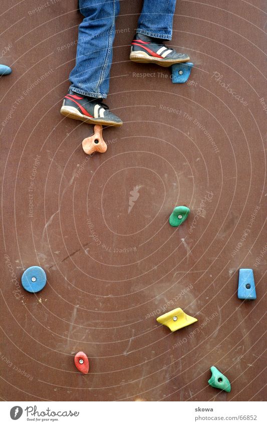 mountaineering on the playground Climbing wall Multicoloured Playground Footwear Dexterity Brown Pants Wall (building) Legs Tall Jeans