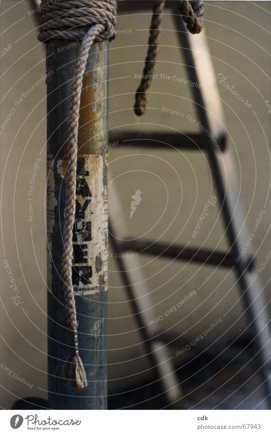 temporise Handbill Assault Information Worn out Attach Stick Repair Lean Hang Still Life Deserted Blur Gray Silver Dark Pole Ladder Rope Advertising
