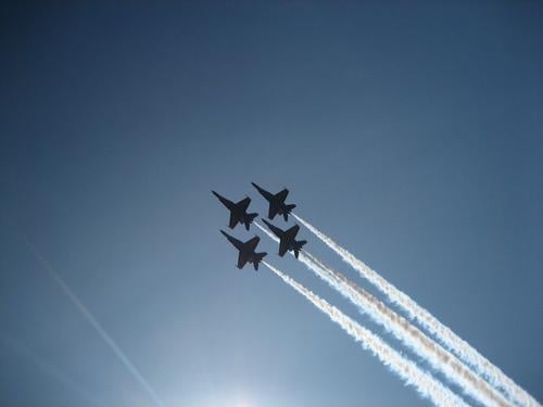Silhouettes of the Blue Angels flight demonstration squadron on a blue sky over lake Washington. Airplane War Aerobatics Americas blue angels Jet Sky Sun