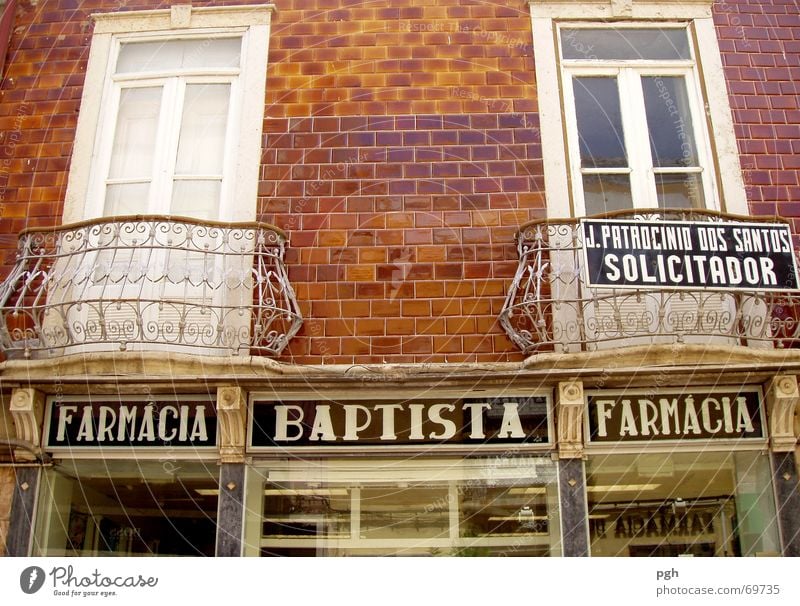 Baptista in Faro Portugal Balcony Handrail Window White Brick Brown Store premises Old town farmacia bapista
