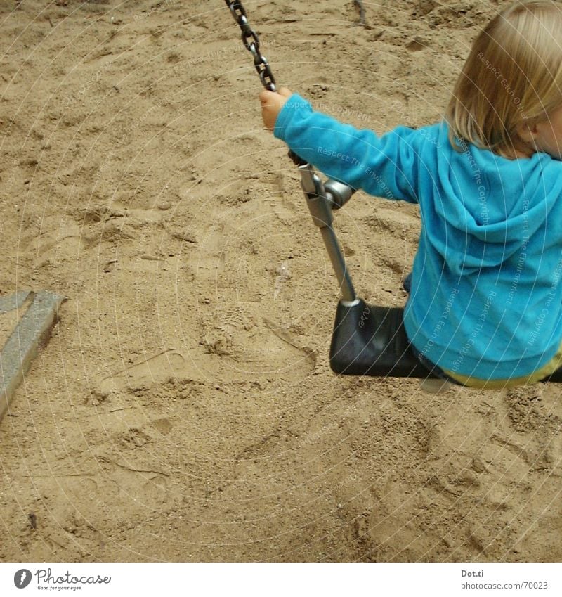 Child on the swing Joy Playing Kindergarten Toddler Infancy 1 Human being 1 - 3 years Sand Park Playground Blonde Footprint Movement To hold on To swing Blue