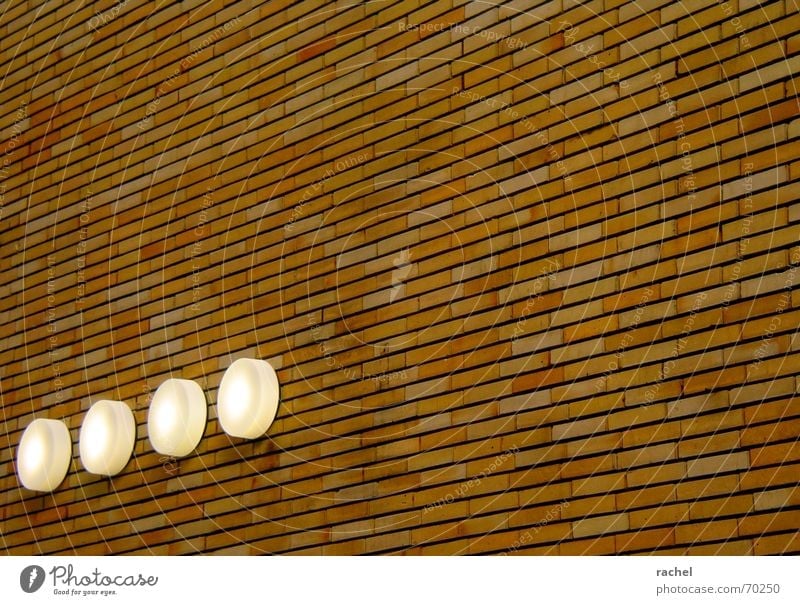neatly lined up Facade Wall (barrier) Brick Outside lights Safety Emergency exit Day Light Lamp Massive Honest Solid Arrangement Smoothness Technical Regular