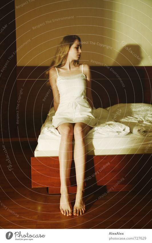 averted Bed Young woman Youth (Young adults) Legs Feet 18 - 30 years Adults Dress Blonde Long-haired Observe Sit Esthetic Large Thin Beautiful Athletic Emotions