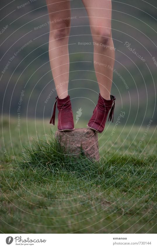 girl with red boots standing on a marker stone on a grassy hill Lifestyle Elegant Style Beautiful Trip Freedom Human being Feminine Young woman