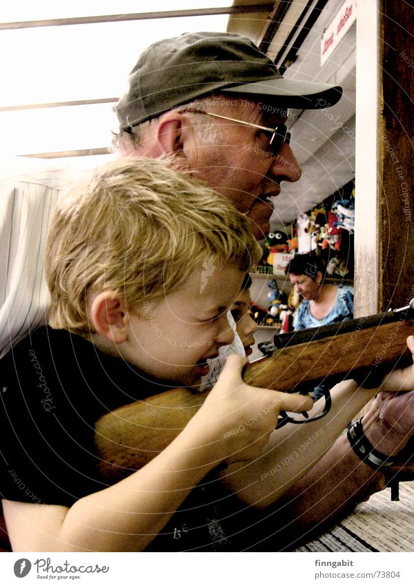 sniper Shooting gallery Rifle Airgun Marksman Grandfather Fairs & Carnivals Exterior shot shooting range grandpa and grandchildren old and young little boy fair