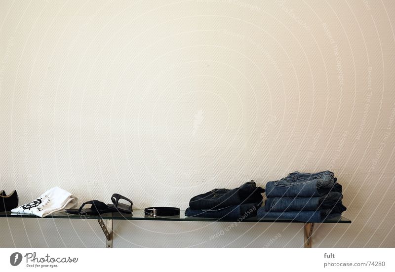 wall-mounted shelf unit Shelves Wall (building) Clothing Textiles Folded Footwear Belt Pane Jeans T-shirt Glass