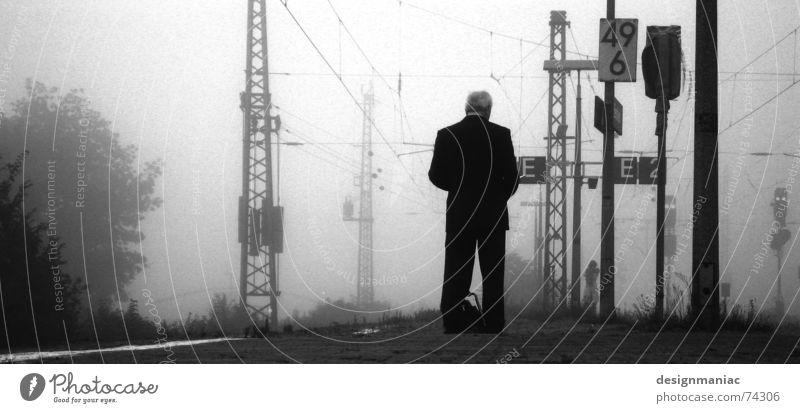 Waiting at the station Bensheim Gray Fog Cold Black Dark White Railroad Platform Man Stand Reading Suit Morning Late Time Gloomy Railroad tracks Grief Lateness