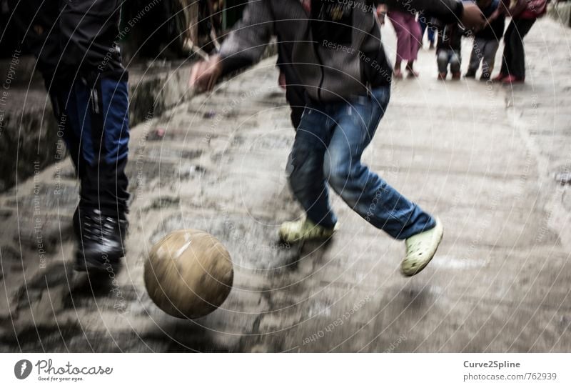 street soccer Sports Soccer Ball Masculine Child Boy (child) Legs Toys Movement Dynamics Street Paving stone Jeans Nepal lucla Playing Leisure and hobbies