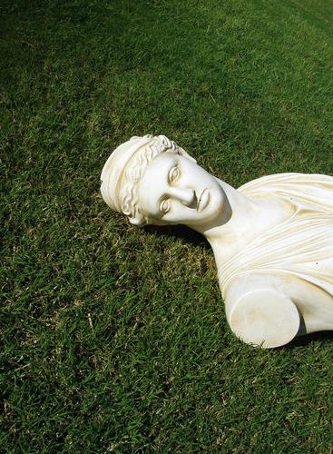 Püppi without arms Deities Green Meadow Grass White Bust Statue Lawn Marble Sculpture Neutral Background Copy Space top Copy Space bottom Historic