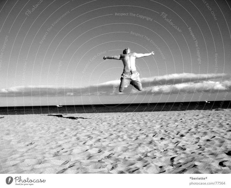 Freedom 1 Man Jump Vacation & Travel Swimming trunks Beach Physics Summer Ocean Wet Salty Sand Warmth Musculature Sky Blue Joy Black & white photo