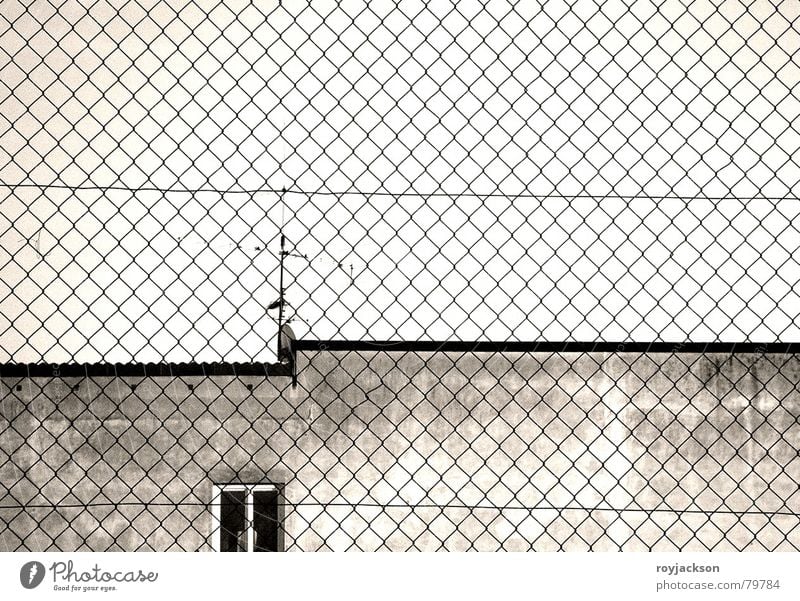 constrictive sight Penitentiary Convict Jail sentence Obstinate Fence Building Window Captured Antenna Gray Wall (building) Wire netting fence Sky Window board