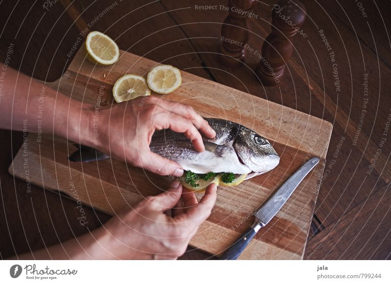 DORADE Food Fish Lemon Nutrition Lunch Knives Chopping board Feminine Hand Fresh Healthy Delicious Natural Wooden table Healthy Eating Colour photo