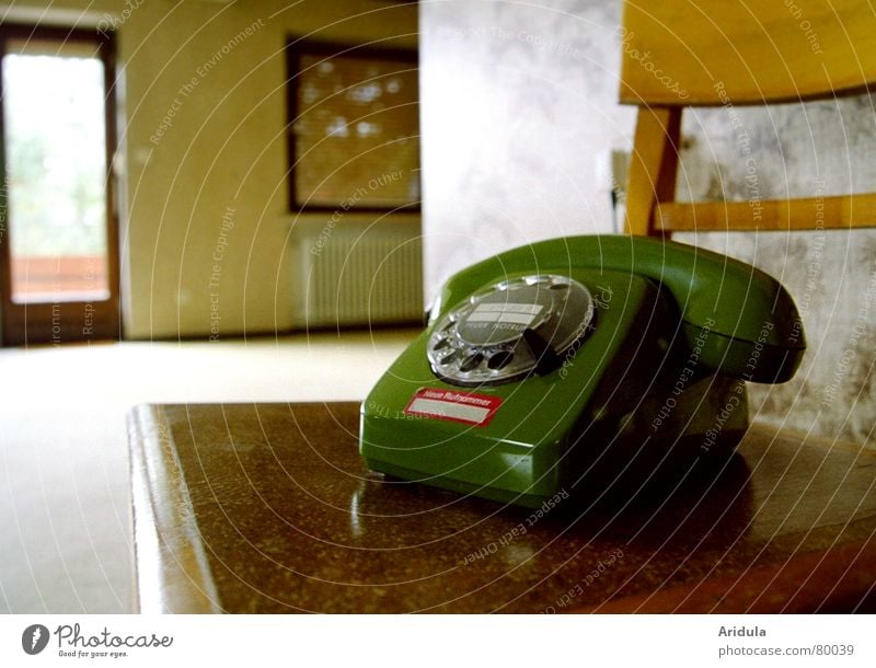 Old green phone in empty living room Telephone Living room Potter's wheel Window Empty Wood Grief Roller blind Loneliness Compromise Remote