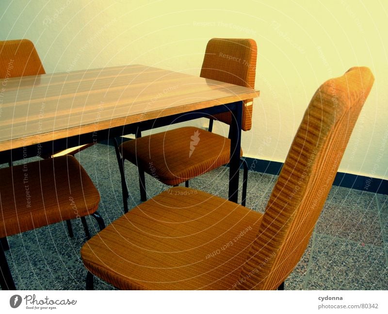 Between the chairs Colour photo Detail Furniture Chair Table Education Work and employment Meeting Old Think Communicate Sit Retro Bolster Empty Wall (building)