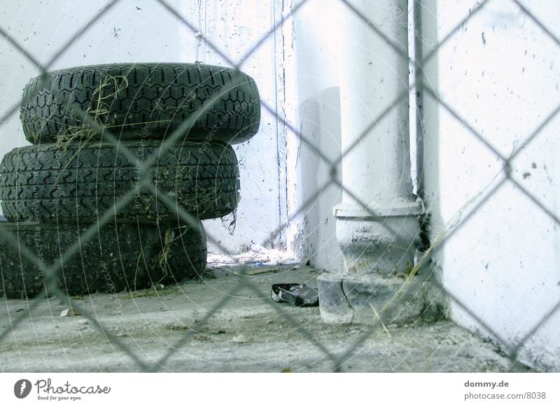 tire stacks Garage Fence Shaft of light Dust Long exposure Metal spiderweb