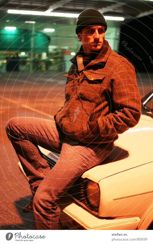 sitting waiting wishing Night Parking lot Light Flexible Man Easygoing Jacket Winter Cold Date Cap Scarf Supermarket Human being Evening Car Old