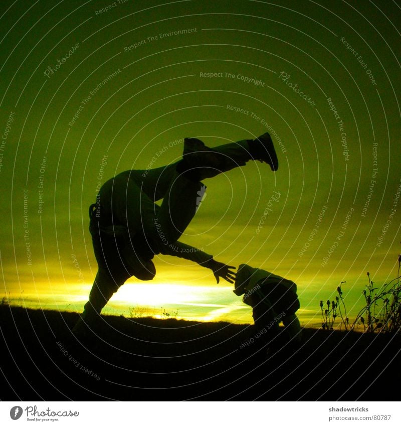 Capoeira - Despite the cold - slide 1 Jump Green Yellow Footstep Tread Fight Clouds Vantage point Panorama (View) Square Sunrise Sunset Back-light Light