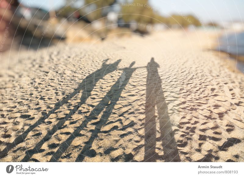 Shadows on the beach Lifestyle Vacation & Travel Tourism Far-off places Summer Summer vacation Sun Beach Ocean Human being Father Adults Brothers and sisters 3