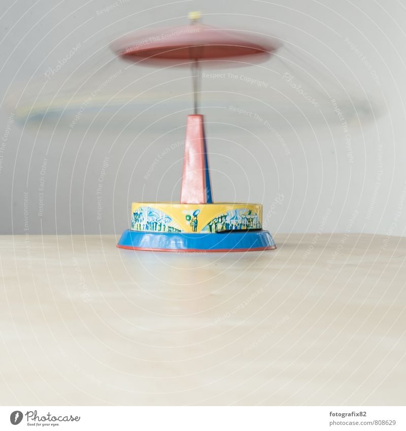 let the world revolve. Sign Speed Blue Yellow Green Red Life Carousel Toys Movement Kinetic energy Rotate Rotation Tin Tin toy Colour photo Interior shot