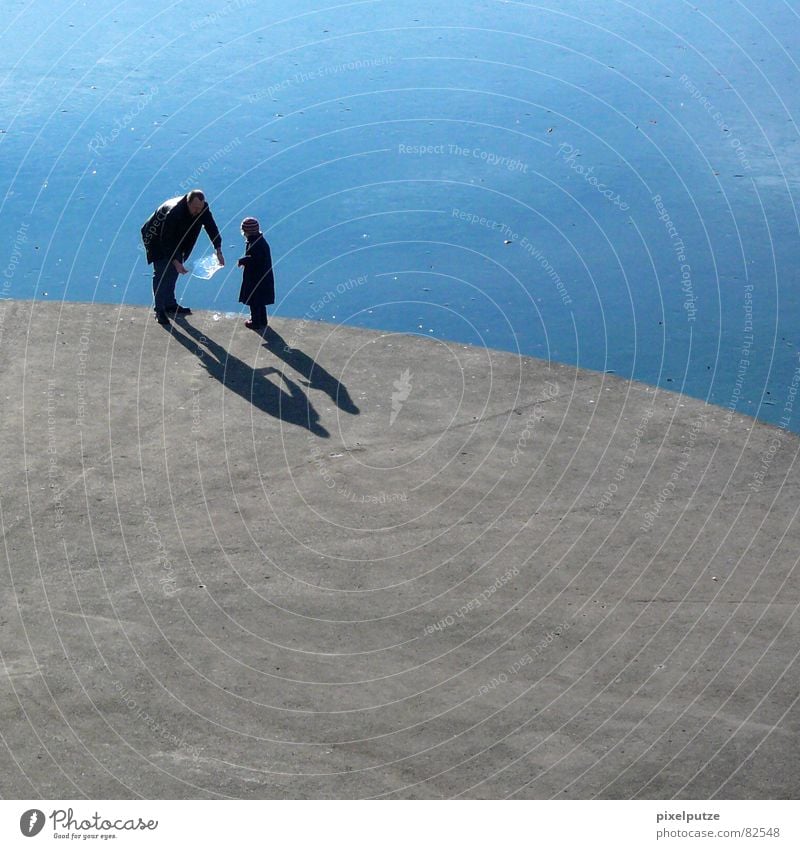 ice-cold games Lake Ice-cream vender Thorough Splashing Concrete Hard Round Platform Father Daughter Child Stand Shadow Curved Delicious Ice floe Body of water