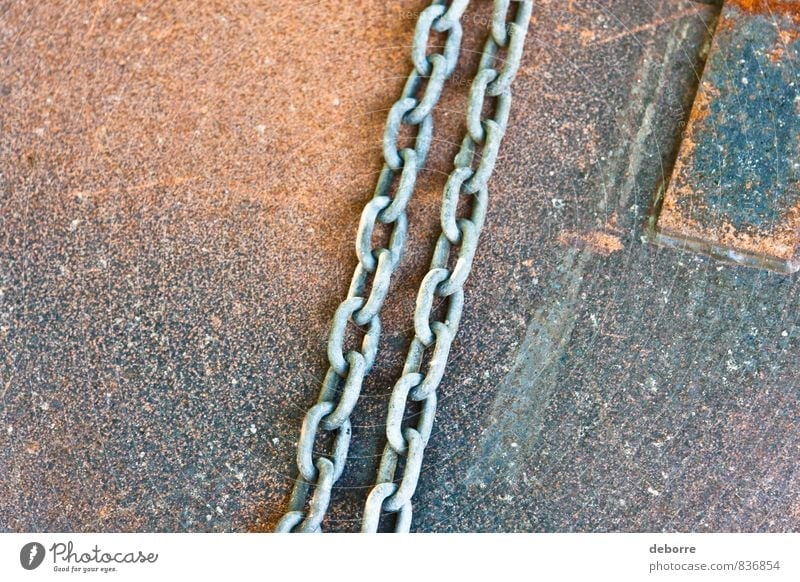 Metal chains lying on a rusty metal sheet. Rust Chain link Industrial Steel Hard