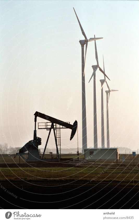 Oil versus wind power Wind energy plant Oil production Oilfield Industry windmills Energy industry oil deposits Pumpjack fossil energy sources