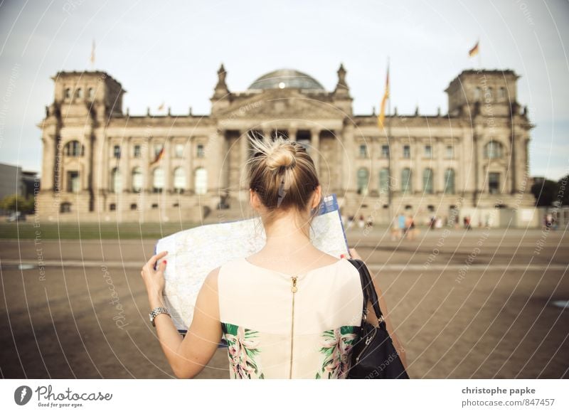 blonde woman looks at city map of Berlin in front of Reichstag Map of the city Young woman Capital city Blonde City trip Tourist Attraction Sightseeing Building