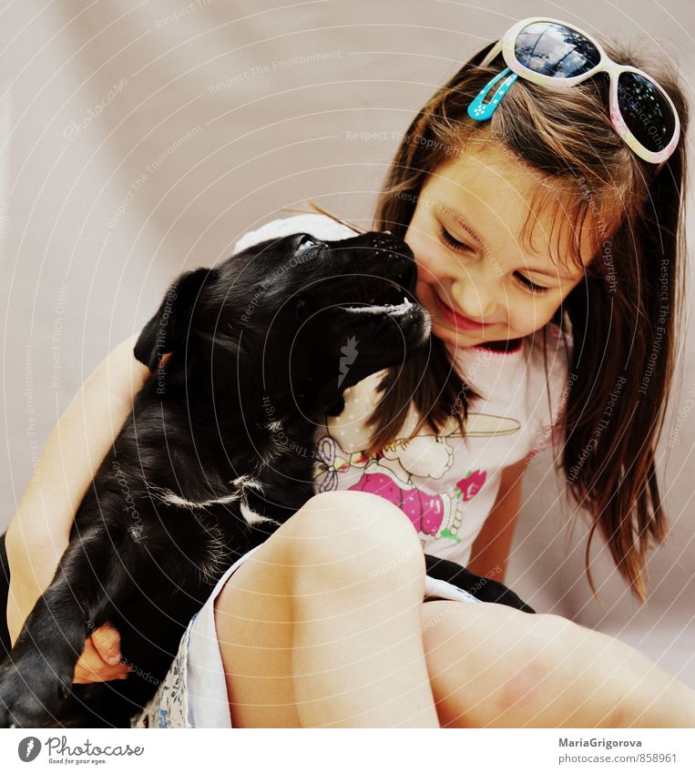 Happy girl with a dog Playing Human being Feminine Child Girl Face 1 3 - 8 years Infancy Animal Pet Dog To enjoy Kissing Love Beautiful Emotions Joy Happiness