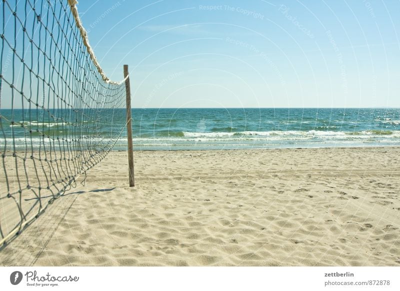 Beach volleyball net directly on the beach with sea in the evening