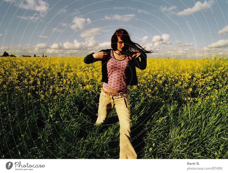 getaway Oilseed rape oil Canola Canola field Sky blue Clouds Bad weather Going Escape Flee Woman Long-haired Cardigan Flares Green Yellow Walking Summer
