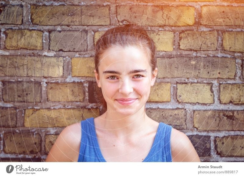 Portrait in front of brick wall Lifestyle Contentment Summer Human being Feminine Woman Adults Youth (Young adults) 1 13 - 18 years Child Wall (barrier)