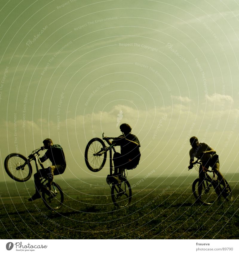 the world is a playground Cycling Bicycle Man Masculine Motorcyclist Romp Clouds Green Playing Exterior shot Happiness Exuberance Joy Group Sports willing