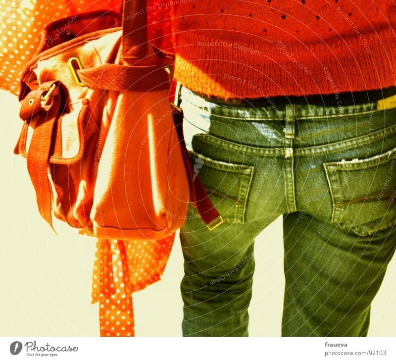 orange bag orange sweater is clear Red Sweater Bag Youth (Young adults) Woman Lady Jacket Exterior shot Going In transit Colour Jeans blue Cotton Hind quarters