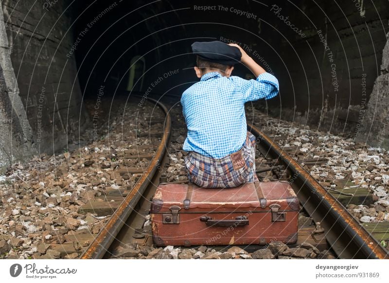 Child in vintage clothes sits on railway road Vacation & Travel Trip Human being Girl Boy (child) Infancy Nature Transport Railroad Suitcase To fall Sit Sadness