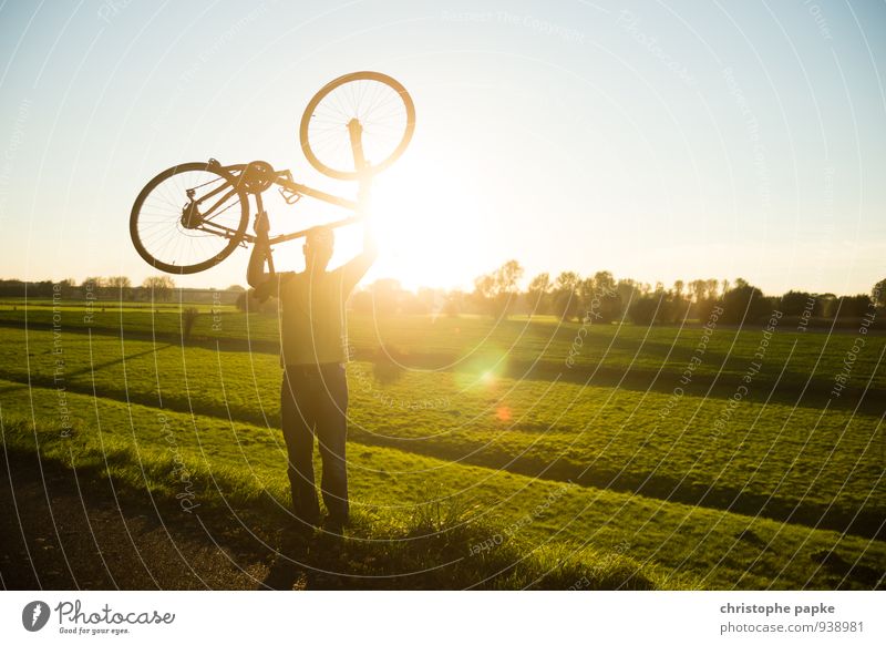 Man holding bike over head in backlight Bicycle Mountain bike Young man Leisure and hobbies Lift Sports Fitness Sports Training Success Cycling