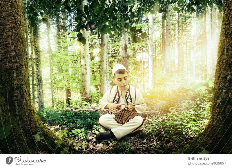 Young boy in Albanian folk costume plays stringed instrument in forest Lifestyle Masculine Child 1 Human being Art Music Musician Nature Spring Summer