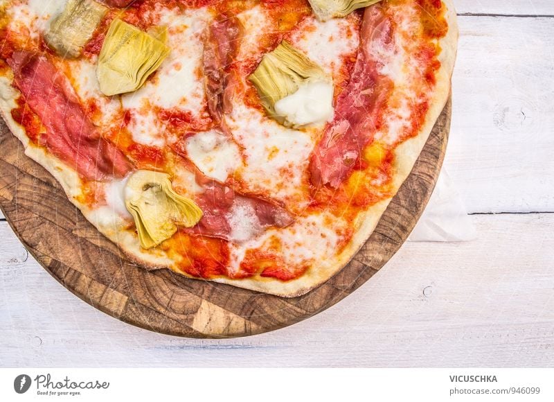 Pizza with artichokes on cutting board Meat Cheese Vegetable Bread Nutrition Lunch Dinner Lifestyle Leisure and hobbies Brown Yellow Red White