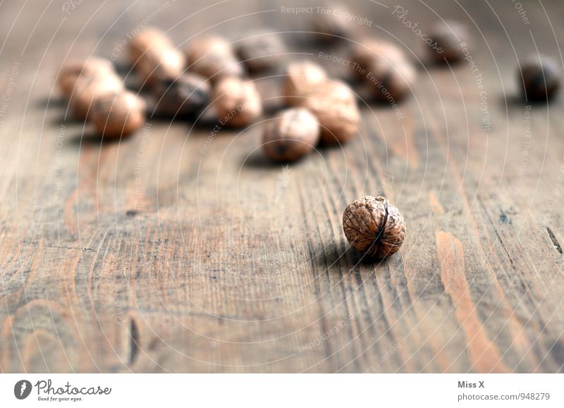 nuts Food Nutrition Organic produce Vegetarian diet Table Wood Brown Walnut Nutshell Hard Ingredients Wooden table Colour photo Subdued colour Close-up