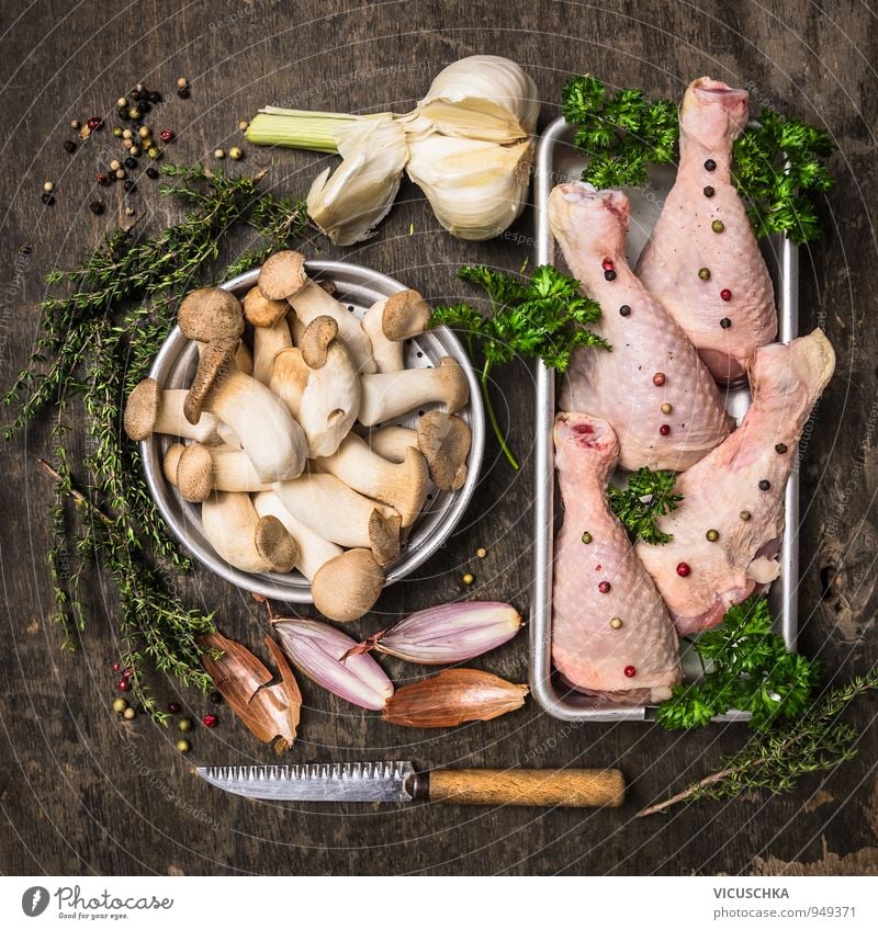 Raw chicken legs with mushrooms, spices and herbs Food Meat Vegetable Herbs and spices Nutrition Lunch Dinner Banquet Organic produce Diet Knives Lifestyle
