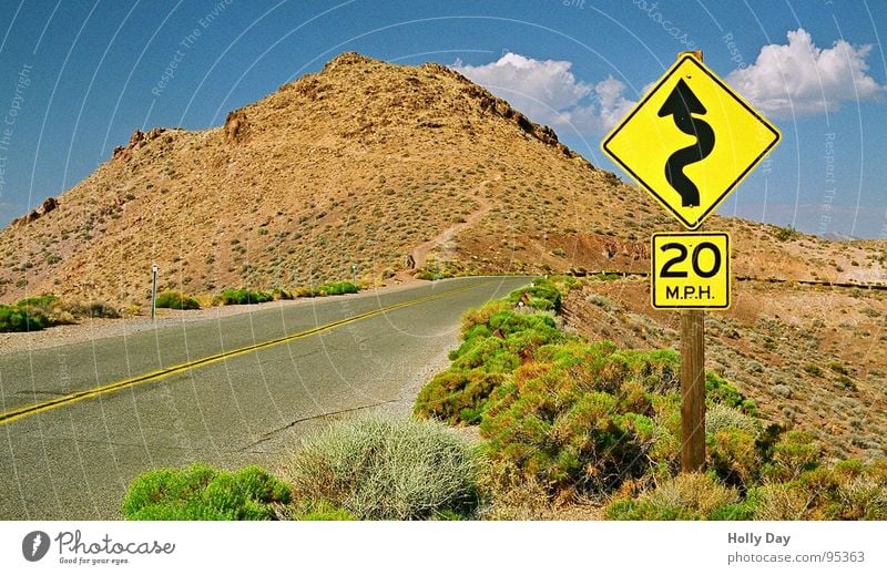 Deadly Curves Road sign Death valley Nationalpark California Clouds Bushes Hill Physics Summer Traffic infrastructure Street sign Desert Sign USA Sky Mountain
