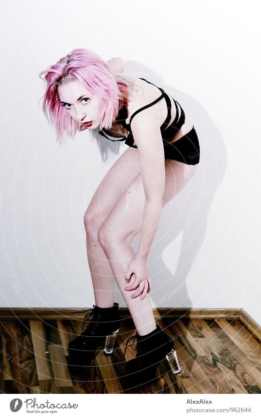 young, leggy woman with pink hair stands on high heels in front of a white Room Night life Entertainment Young woman Youth (Young adults) Hair and hairstyles