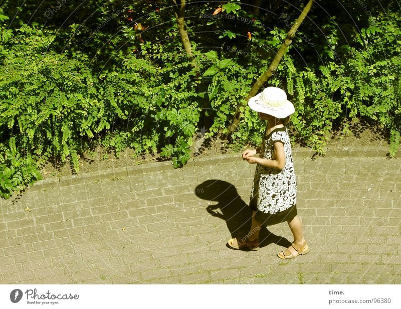 Walking By Myself Shadow Summer Sun Girl Foliage plant Lanes & trails Dress Hat Loneliness Sandal Cobblestones bush
