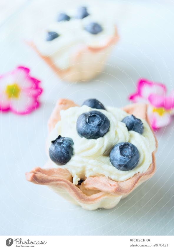 Tartlets with blueberries and pink flowers Food Fruit Dough Baked goods Cake Candy Nutrition Breakfast To have a coffee Banquet Vegetarian diet Diet Style