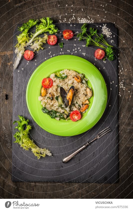 Risotto with mussels, tomatoes and green salad . Food Seafood Vegetable Lettuce Salad Herbs and spices Nutrition Lunch Banquet Organic produce Vegetarian diet