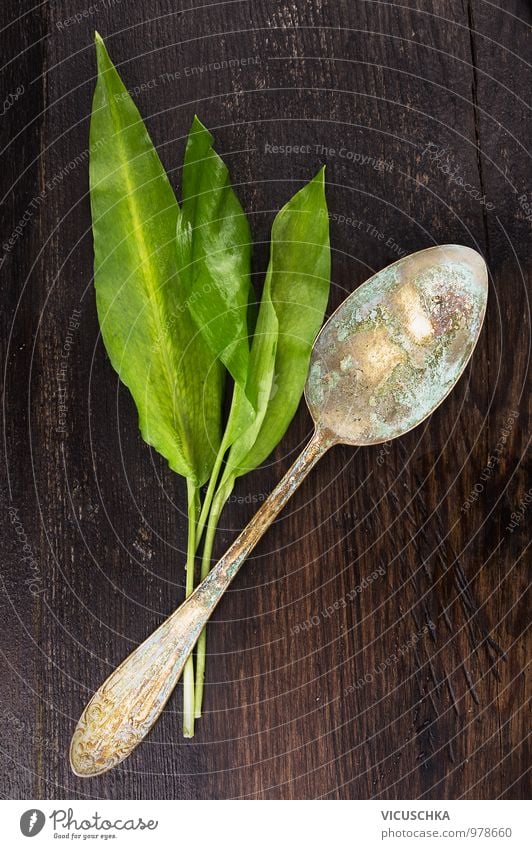 Wild garlic leaves and old spoon on a dark wooden table Food Lettuce Salad Herbs and spices Nutrition Organic produce Vegetarian diet Diet Spoon Style Design